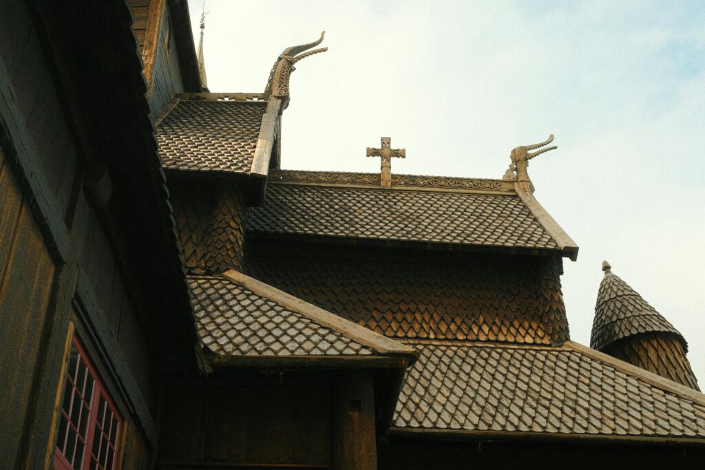 Close-up of ornate wooden roof on traditional Nordic stave church.