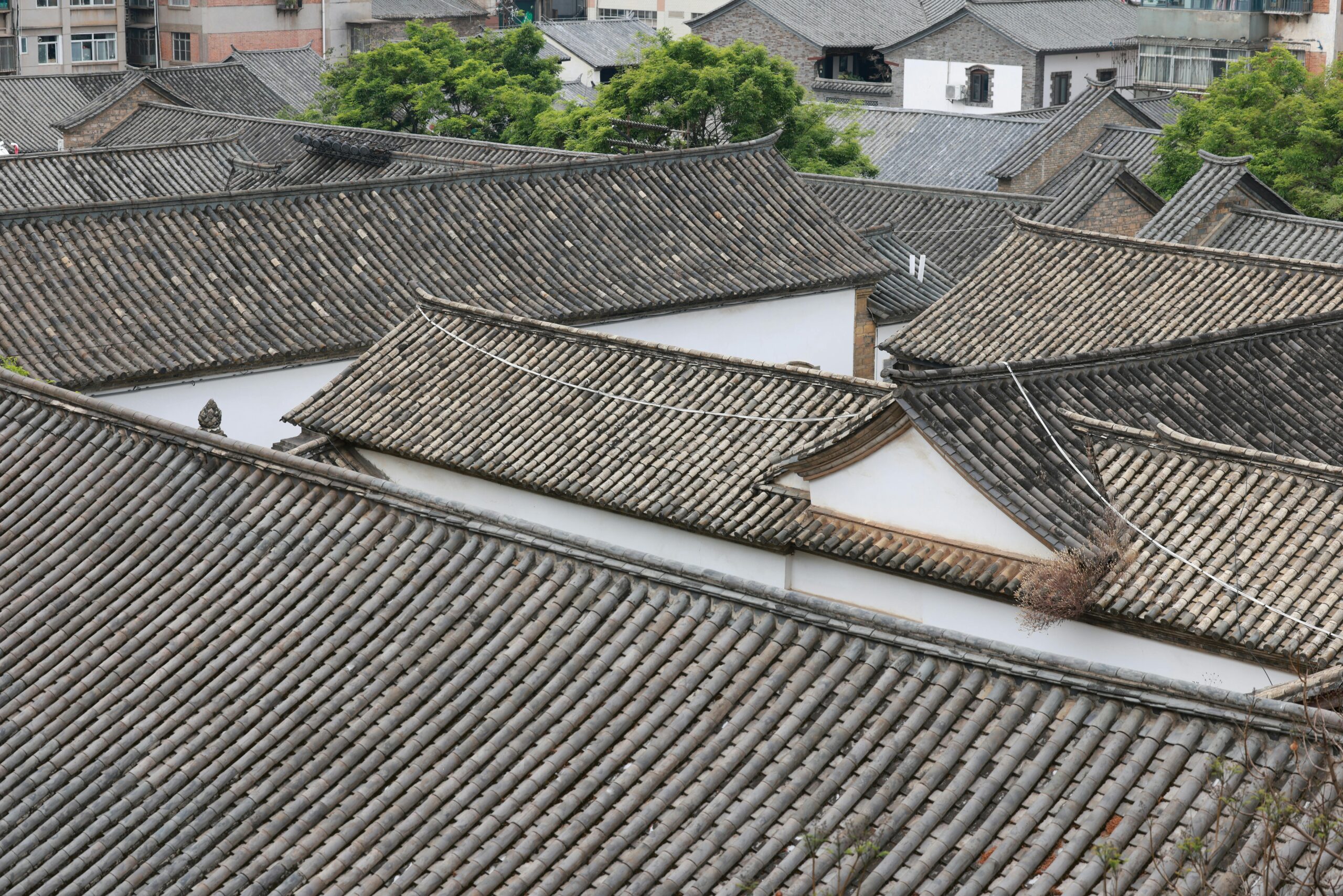 Overhead view of traditional tiled rooftops in an ancient Chinese village.